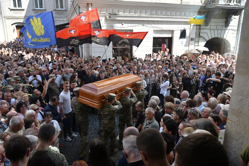 Crowds surround the coffin of Iryna Farion during a funeral ceremony in Lviv (Mykola Tys/AP)