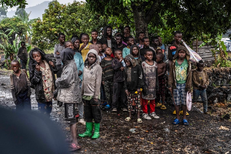 Congolese children watch the deployment of government and UN troops outside Goma (Moses Sawasawa/AP)