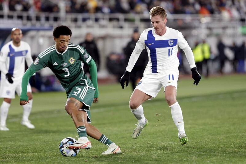 Jamal Lewis of Northern Ireland, left, is challenged by Rasmus Schuller (Roni Rekomaa/AP)