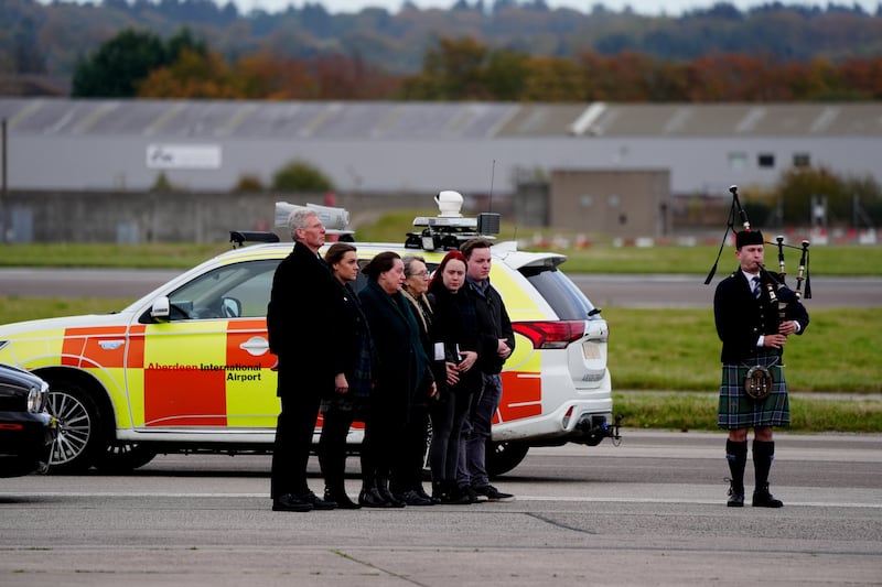 Members of the family and acting Alba leader Kenny MacAskill (left) greet the coffin