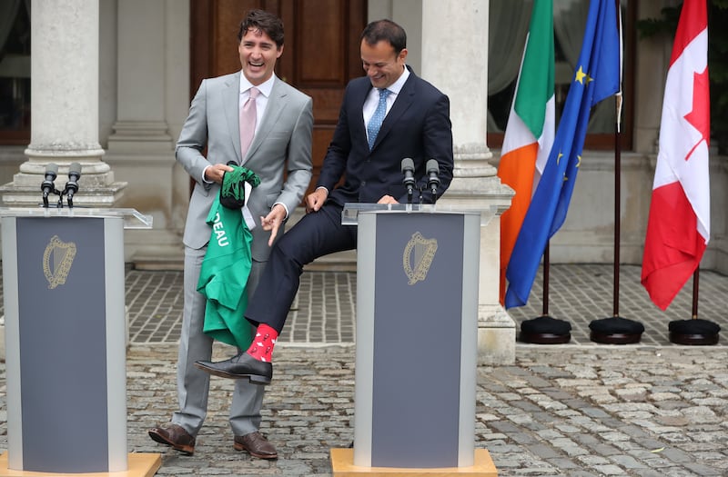 Leo Varadkar shows off his Canadian-themed socks during a press conference with Canadian Prime Minister Justin Trudeau