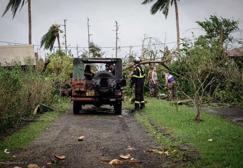 Soldiers and rescue workers clearing a street in the French territory of Mayotte in the Indian Ocean after Cyclone Chido (Securite civile via AP)