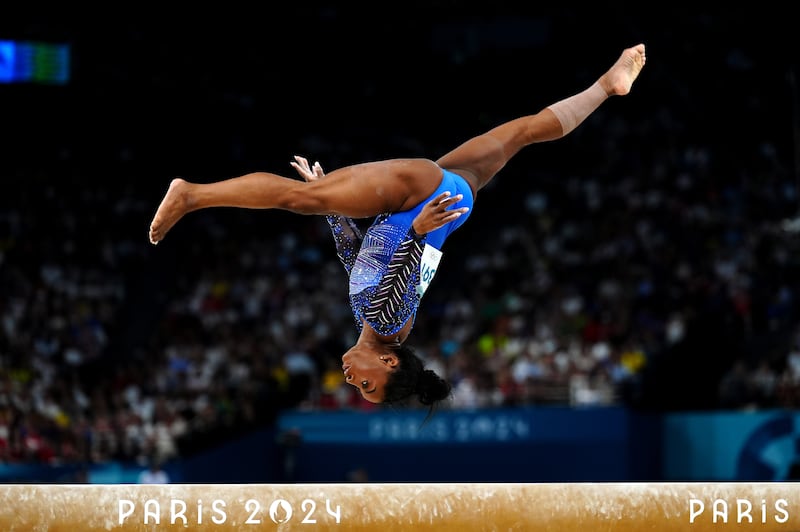 Simone Biles performs on the balance beam during the Women’s All-Around Final at the Bercy Arena