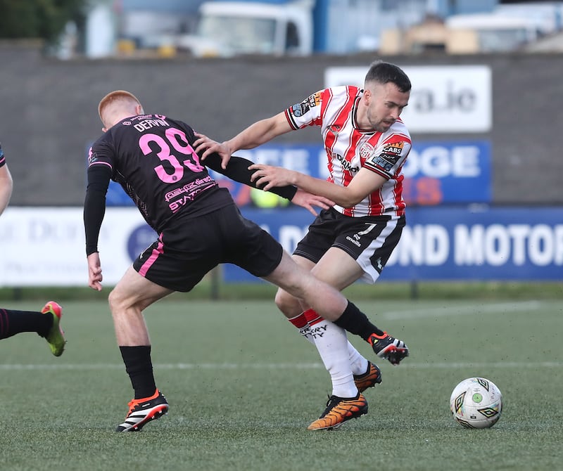 Derry City's Michael Duffy gets away from Aodh Dervin of Dundalk at the Brandywell on Friday night. Picture Margaret McLaughlin