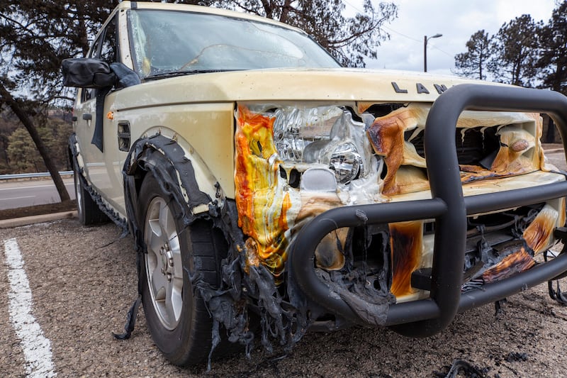 The front of a car melted in the intense heat of the South Fork Fire in the mountain village of Ruidoso (Andres Leighton/AP)