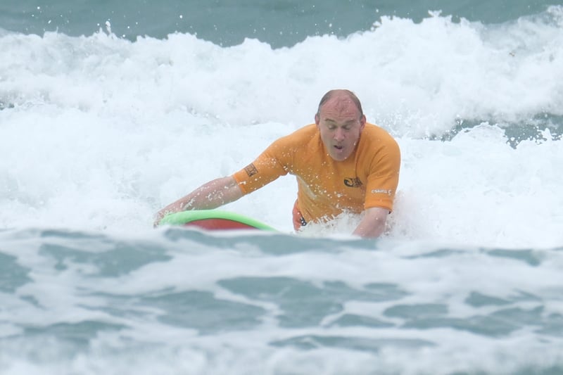Sir Ed Davey battles the surf as part of his General Election campaign