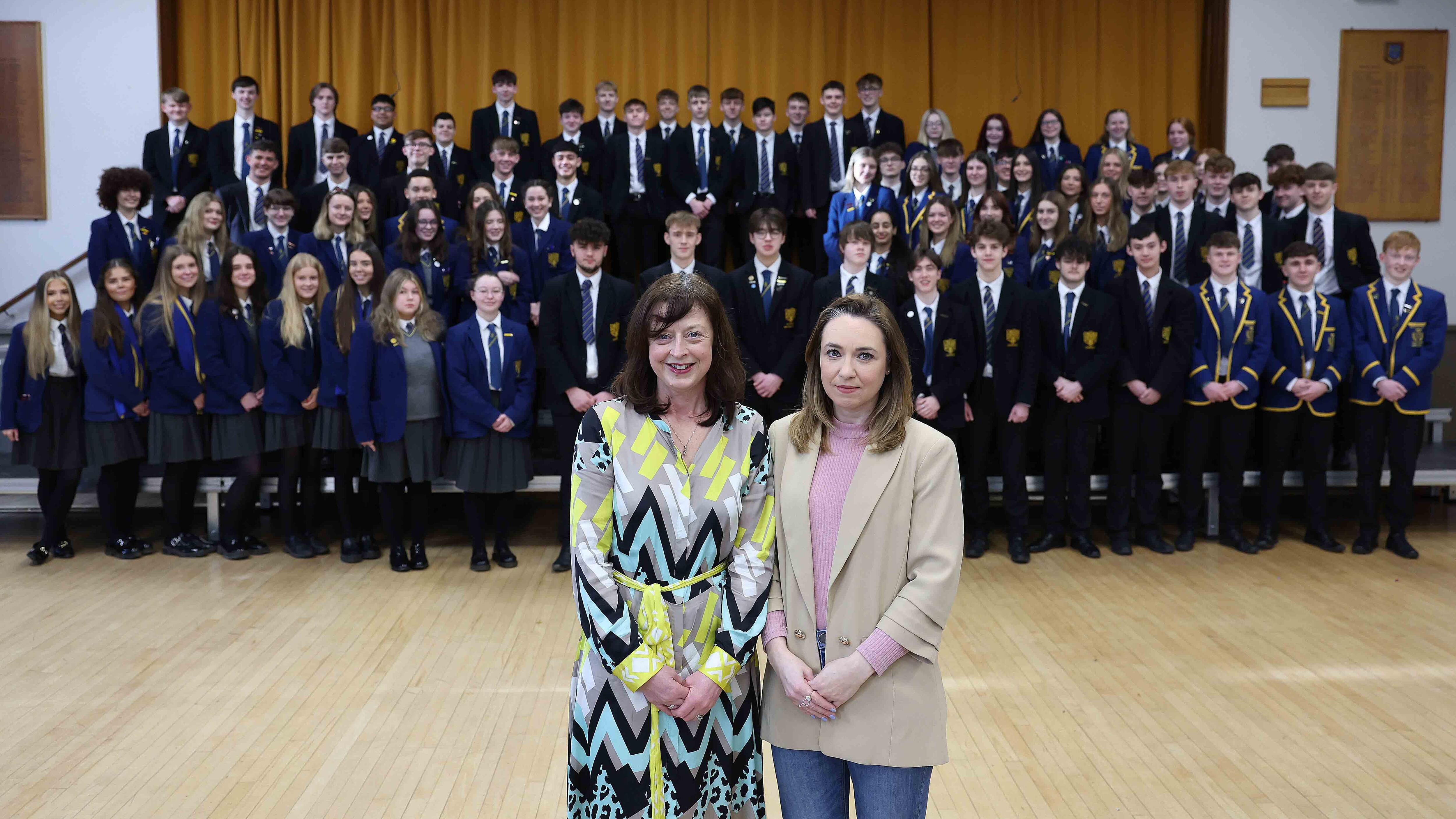 Amy Adair-McCourt (right) and Charlotte Weir, principal of Belfast High School with some of the 100 Belfast High pupils set to get a potentially life-saving scan