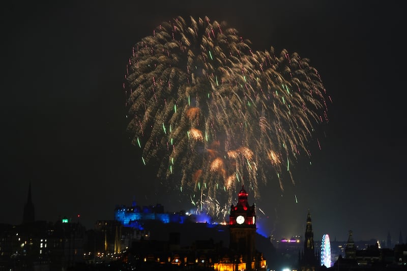 Fireworks explode over Edinburgh Castle during the street party for Hogmanay New Year on January 1 2023