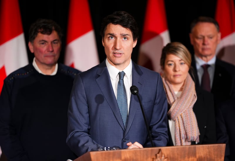 Mr Trudeau, joined by Minister of Finance Dominic LeBlanc, back left to right, Minister of Foreign Affairs Melanie Joly, Minister of Public Safety David McGuinty (The Canadian Press via AP)