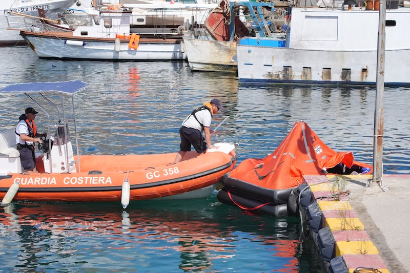 The coastguard handles an inflatable emergency lifeboat in Porticello Harbour, where the search continues for Mike Lynch and his daughter