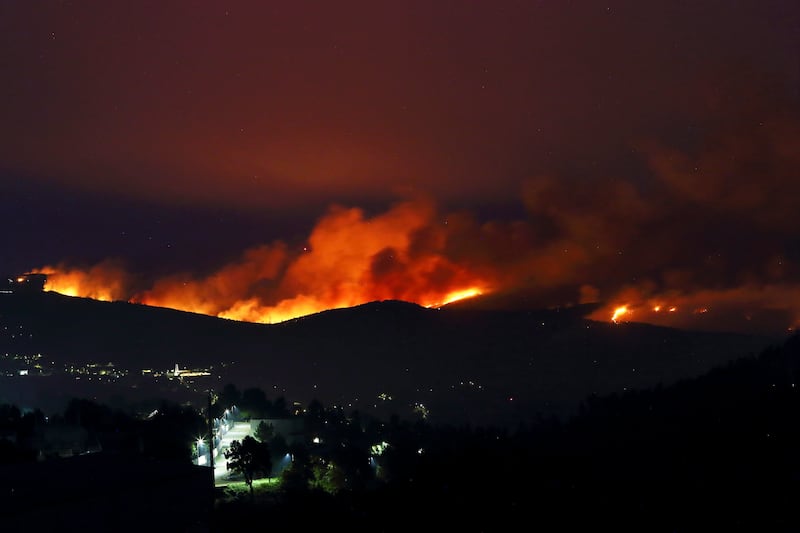 Fires rage on the hills around a town in northern Portugal (Bruno Fonseca/AP)