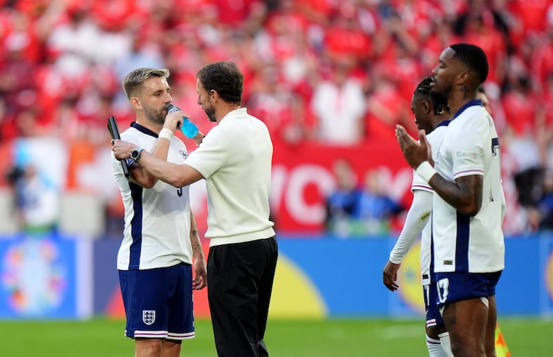 England manager Gareth Southgate, centre, speaks to Luke Shaw, left, before the penalty shoot-out against Switzerland