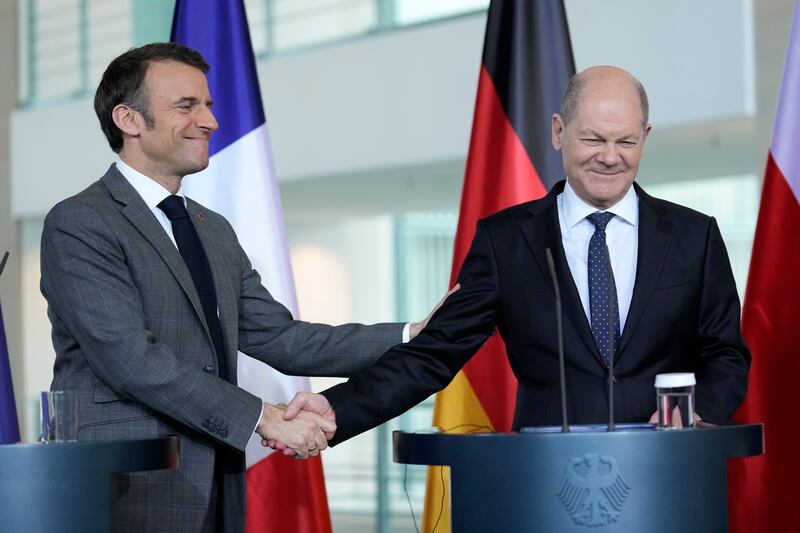 Germany’s Olaf Scholz and French President Emmanuel Macron shake hands at the press conference (Ebrahim Noroozi/AP)