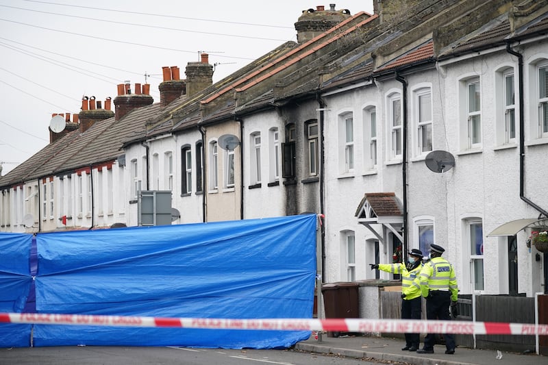 Police at the scene in Collingwood Road, Sutton, south London, where two sets of twin boys, aged three and four, died in a house fire