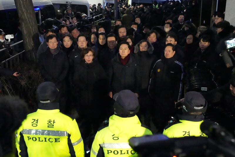 Politicians from the ruling People Power Party speak to media outside of the gate of the presidential residence in Seoul (Lee Jin-man/AP)