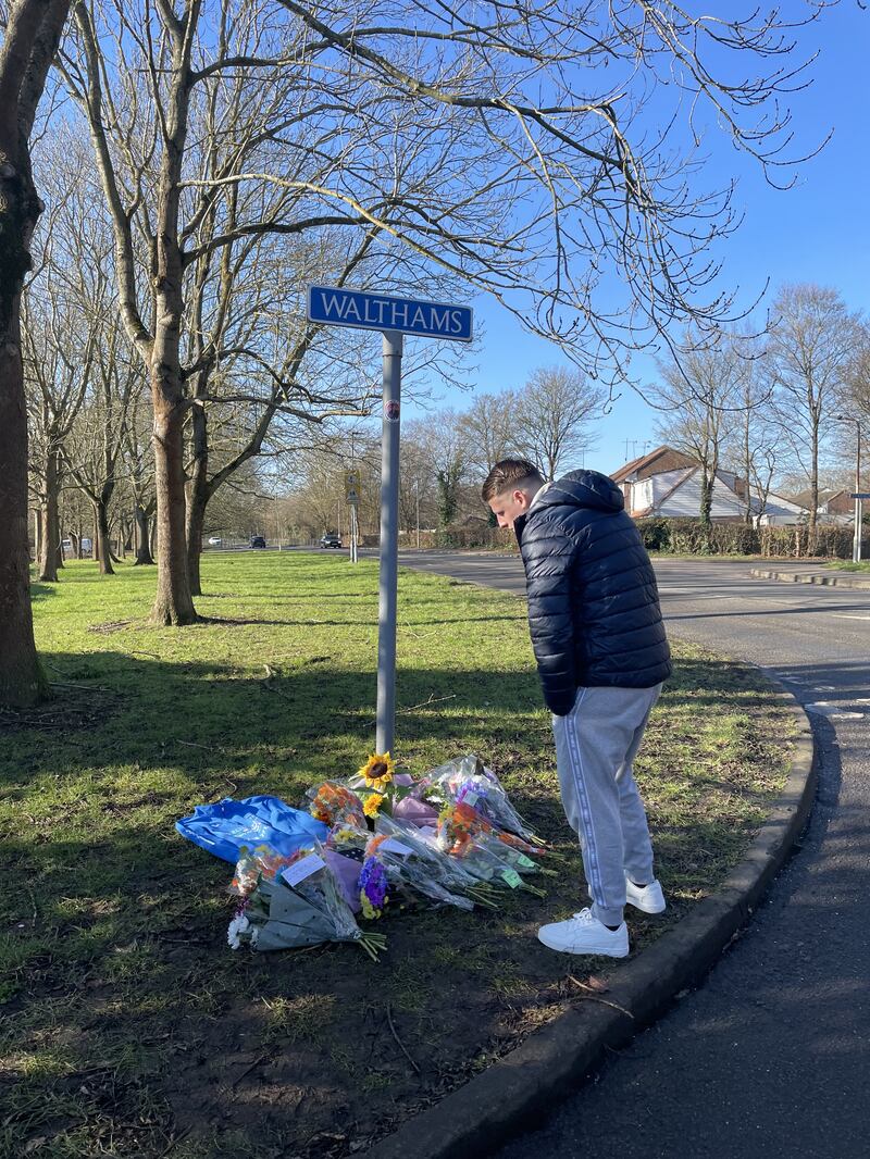 Members of the community pay tribute near the scene of a collision where two children died in Pitsea, Essex