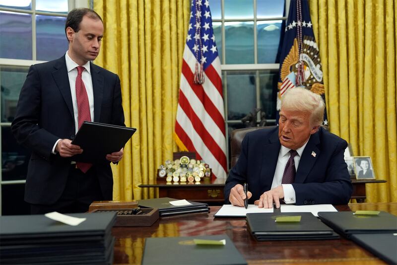 President Donald Trump signs an executive order in the Oval Office (AP/Evan Vucci)