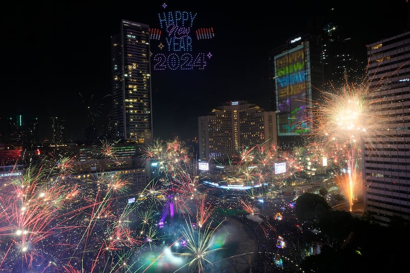 Fireworks explode as thousands of people gather to attend the new year celebrations in the main business district in Jakarta, Indonesia (Achmad Ibrahim/AP)