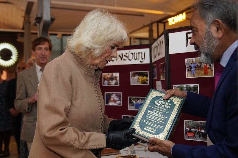 Queen Camilla is handed a copy of the Quran by John Mustafa of the Shrewsbury Interfaith Forum