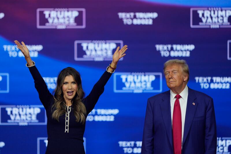 Donald Trump and South Dakota Governor Kristi Noem dance to the song YMCA (Matt Rourke/AP)