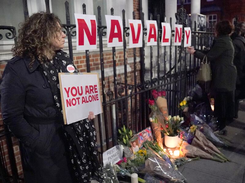 People take part in a protest opposite the Russian Embassy in London