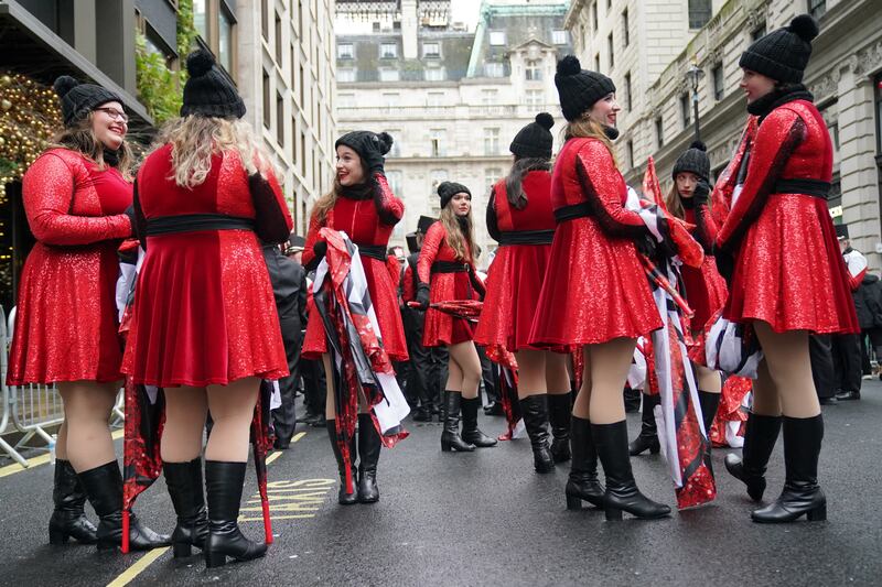 Marching band members prepare for the New Year’s Day parade in London, which was delayed due to the weather