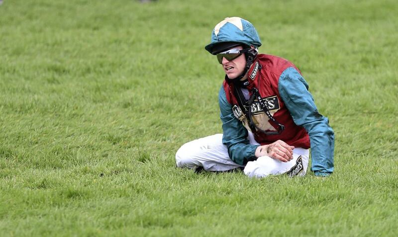 The fall guy. Brian Hughes takes a tumble at Aintree. 