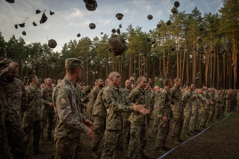 Soldiers celebrate the end of their training at a military base close to Kyiv (AP)