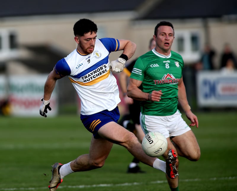 Errigal Ciaran midfielder Joe Oguz is shadowed by Cargin veteran Michael McCann.