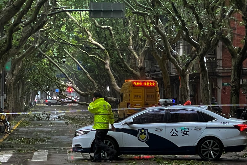 Policemen close a road in the aftermath of Typhoon Bebinca in Shanghai, China (Chinatopix Via AP)