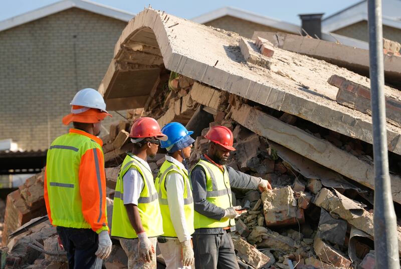 Emergency workers on the scene of the building collapse in George, South Africa (Nardus Engelbrecht/AP)