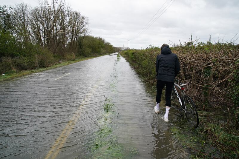 A person walks through flood water in Littlehampton