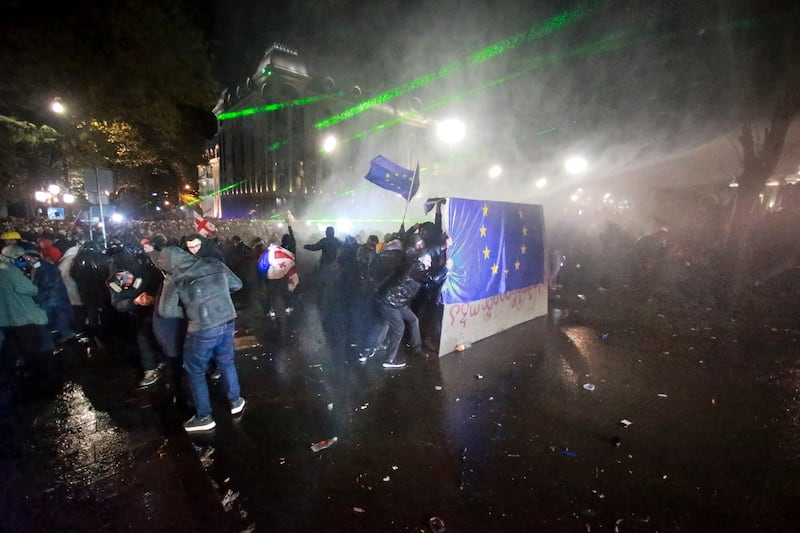 Protesters hold an EU flag during a rally outside the parliament building in Tbilisi, Georgia (Zurab Tsertsvadze/AP)