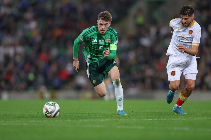 Northern Ireland captain Conor Bradley runs with the ball away from Bulgaria's  Hristiyan Petrov.