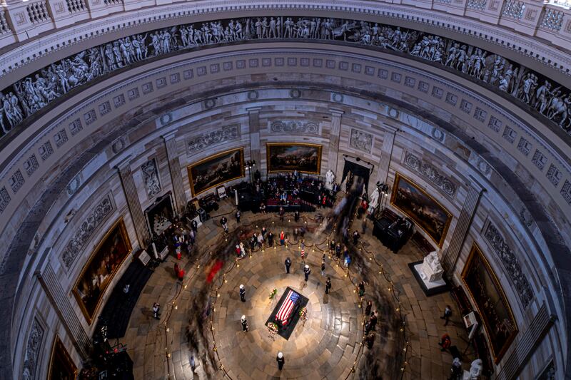 The flag-draped casket of former President Jimmy Carter lies in state at the rotunda of the US Capitol (Andrew Harnik/Pool/AP)