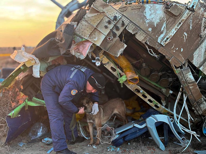 A rescuer searches the wreckage of the Azerbaijan Airlines Embraer 190 (Kazakhstan’s Emergency Ministry Press Service/AP)