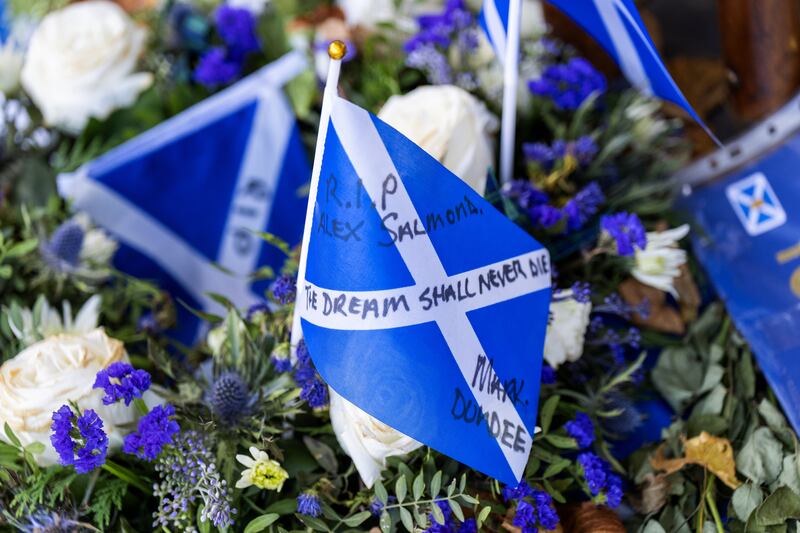 Tributes outside the Scottish Parliament building in Edinburgh ahead of a motion of condolence for the former first minister Alex Salmond