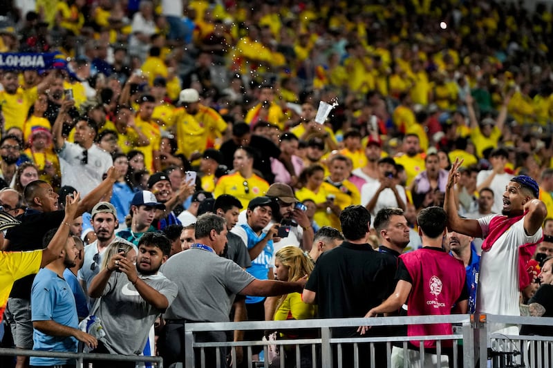 Uruguay’s Ronald Araujo, right, argues with fans at the end of the Copa America semi-final (Julia Nikhinson/AP)