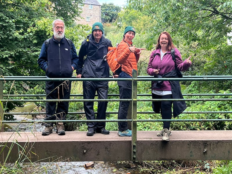 The group, pictured crossing the border into England, are more than halfway into their epic fundraising walk.