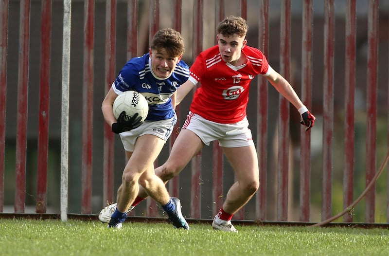 Four Masters Eoghan O'Neill shrugs off Magherafelt's Kian Maynes in a challenge in the Ulster Minor Club Football Final