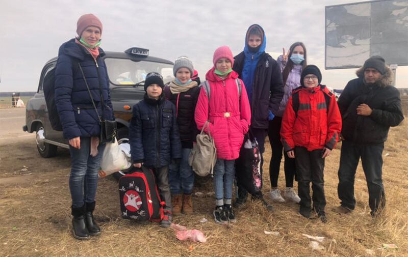 A woman and her six children were driven from Lviv to the Polish border crossing on March 9, by Roman Tymchyshyn. Alongside them in the photograph is a man from Yemen who has been living in Ukraine for many years after fleeing conflict in his home country. He is now seeking refuge for a second time