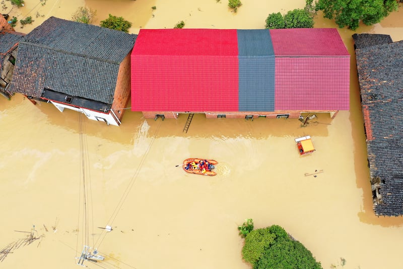 Rescuers use a dinghy to evacuate villagers in Jingtang village, in southern China’s Hunan province (Chinatopix/AP)