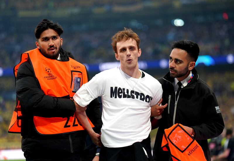 Stewards remove a pitch invader during the Champions League final at Wembley