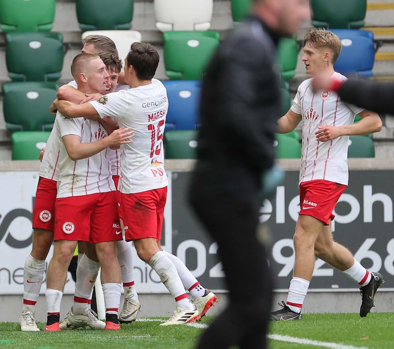 Conor McKendry (left) is mobbed after scoring Larne's winner