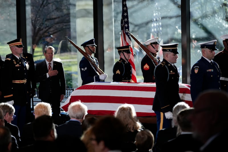 A military body bearer team places the flag-draped coffin of former US president Jimmy Carter on to the catafalque at the Jimmy Carter Presidential Library and Museum in Atlanta (Alex Brandon, Pool/AP)