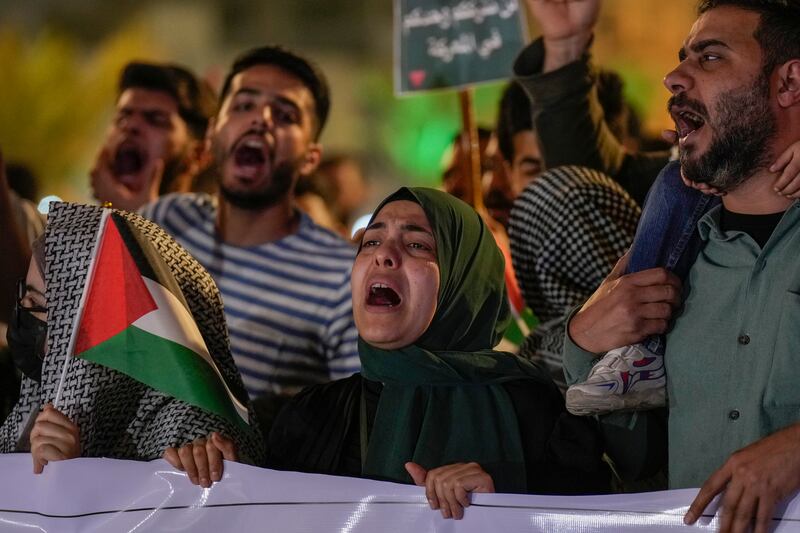 Protesters in Baghdad, Iraq, chant slogans and wave Palestinian flags to show support for Palestinians in Gaza and to condemn Israeli attacks (Hadi Mizban/AP)