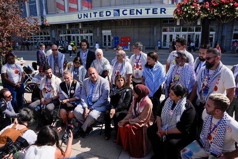 Uncommitted delegates hold a press conference outside the United Centre before the Democratic National Convention (Matt Rourke/AP)