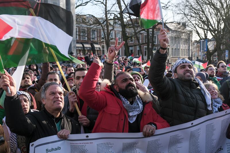 Pro-Palestinian activists react near the International Court of Justice in The Hague, Netherlands (Patrick Post/AP)