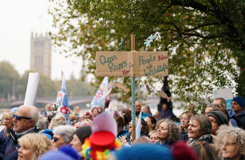 Protesters carried signs and placards as they marched along the River Thames in London