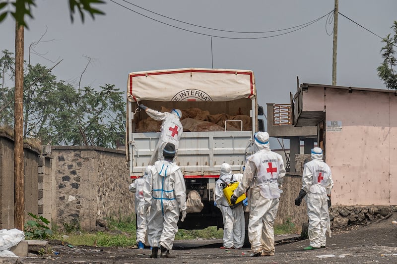 Red Cross personnel load bodies of victims of the fighting between Congolese government forces and M23 rebels in a truck in Goma (Moses Sawasawa/AP)